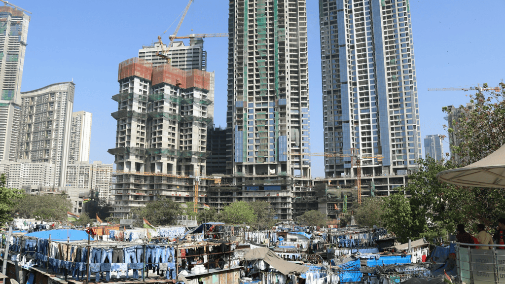 New high-rise towers under construction above a laundry settlement in Mumbai
